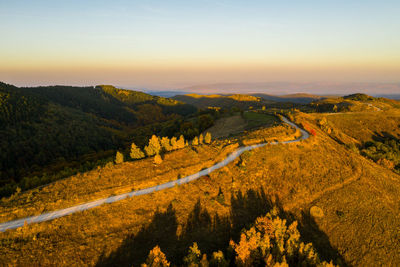 Aerial drone view of winding mountain road at autumn