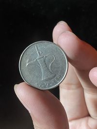 Close-up of hand holding coins