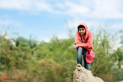 Portrait of fashionable teenager against sky