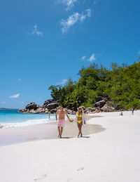 People on beach against sky