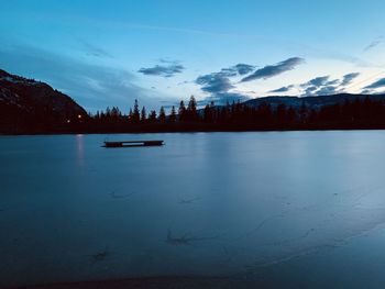 Scenic view of lake against sky at dusk