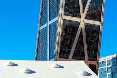 Low angle view of modern office building against clear blue sky