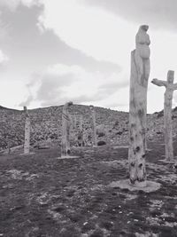 Sculpture on landscape against sky