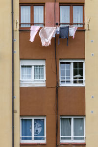 Front of a residential building with clothes dying on a rope.