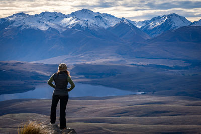 Rear view of woman standing on mountain