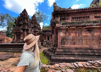 Rear view of woman standing against temple