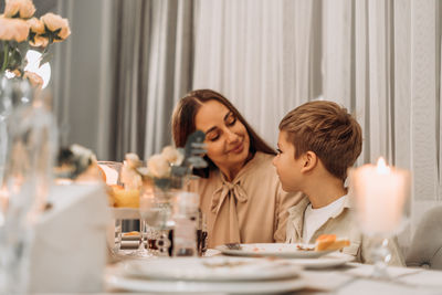 Smiling friends having food at home