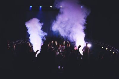 People enjoying music concert at night