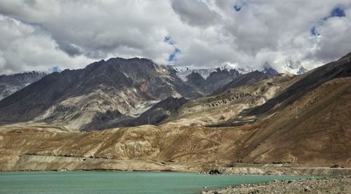 Panoramic view of sea and mountains against sky