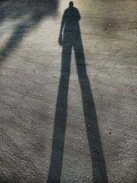 Shadow of person on road