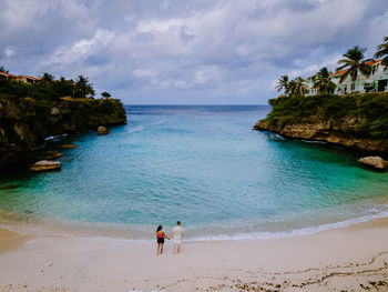 People on beach against sky