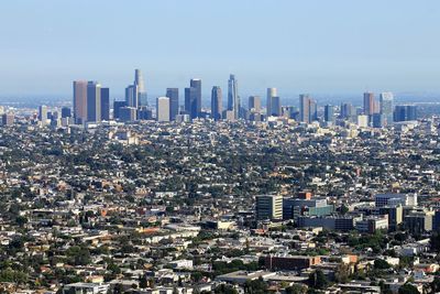 Aerial view of modern buildings in city against sky