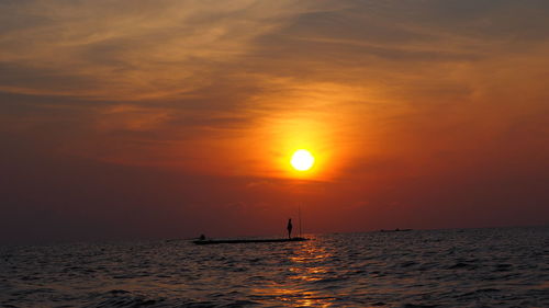 Scenic view of sea against orange sky