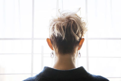 Rear view of woman against window