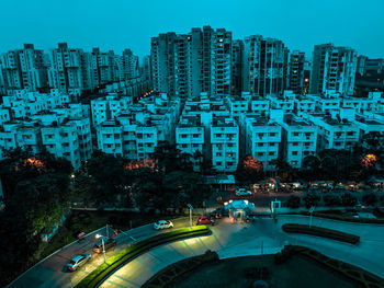 High angle view of city by buildings against sky