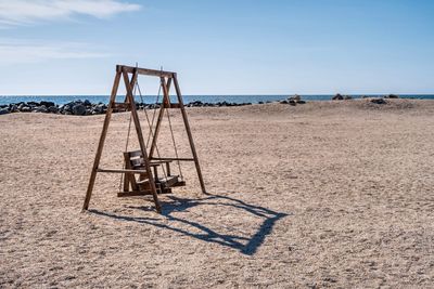 Lifeguard hut on beach against sky