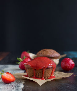 Close-up of muffins with strawberries on table