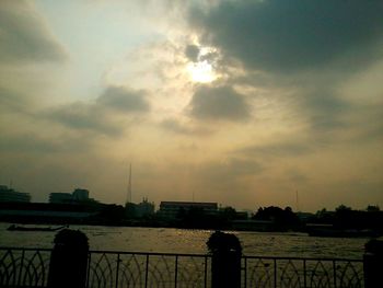 Reflection of cloudy sky on water at sunset