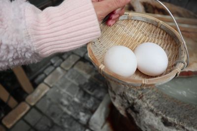 Close-up of hand holding basket