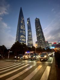 Traffic on road in city against sky