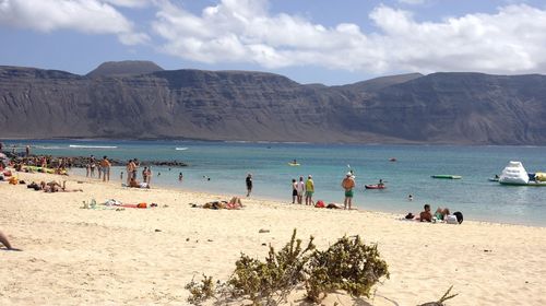 Scenic view of beach against cloudy sky