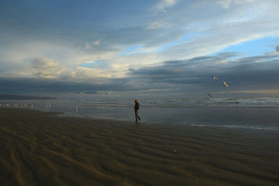 Full length of man on beach against sky