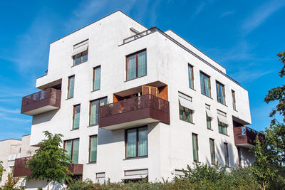 Modern white apartment house with metal balconies seen in berlin, germany