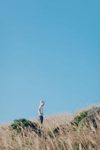 Full length of man on field against clear sky