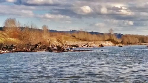 Scenic view of river against sky during winter