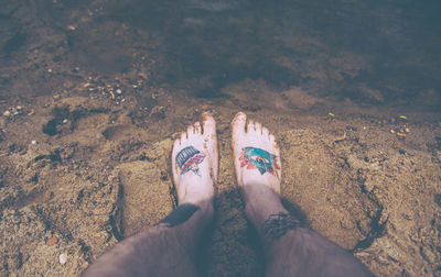 Low section of woman standing on beach