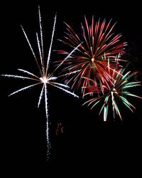 Low angle view of firework display against sky at night