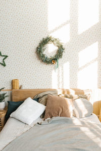 A bed with pillows and christmas decorations in the bedroom in a scandinavian style