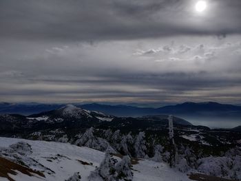 Scenic view of snow covered mountains against sky