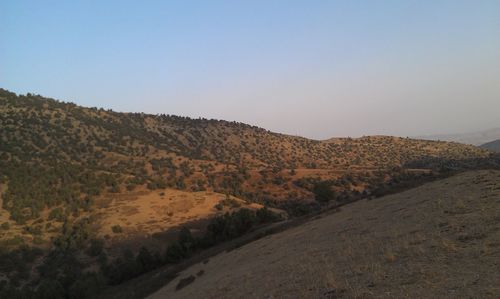 Scenic view of arid landscape against clear sky