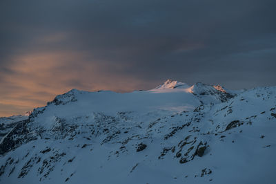 Scenic view of snowcapped mountains against sky during sunset