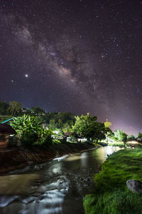 Scenic view of lake against sky at night