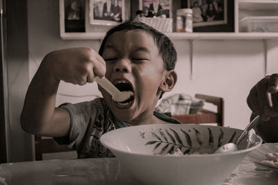 Boy eating food at home