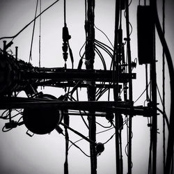 Low angle view of silhouette man against bridge against sky