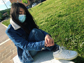 Low section of woman sitting on field