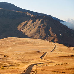 Scenic view of arid landscape against sky