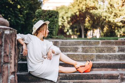 Young woman sitting on steps