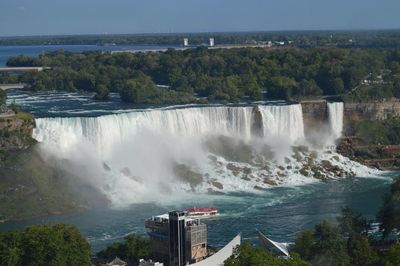 Scenic view of waterfall against sky