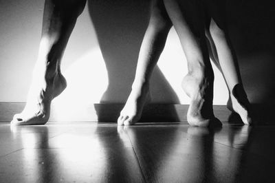 Low section of ballet dancers on floor