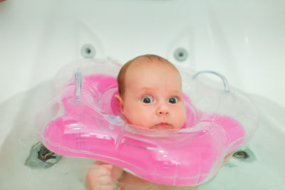 Portrait of cute baby girl in bathroom