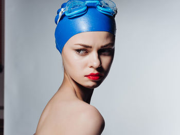 Portrait of woman against blue background