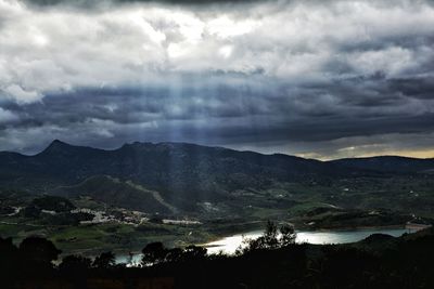 Scenic view of landscape against dramatic sky