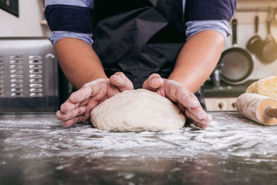 Midsection of man preparing food on table