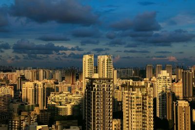 Cityscape against cloudy sky