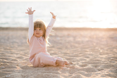 Portrait of boy playing with sand at beach