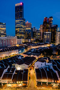 High angle view of illuminated buildings against sky at night